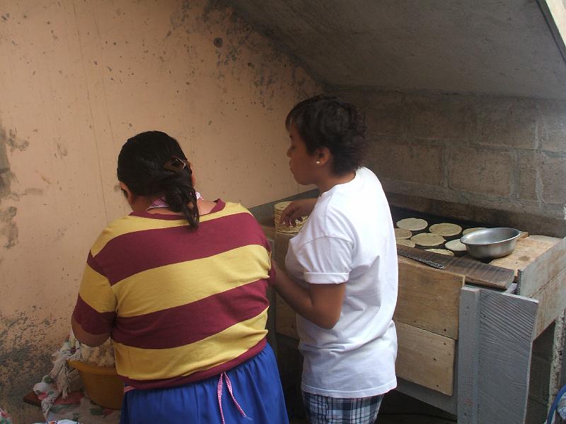 DSCF2121.JPG - Making tortillas...  Elsa and daughter Sandra.  They had to hide here under the new steps because construction pushed them out of their normal spot in the garage temporarily.