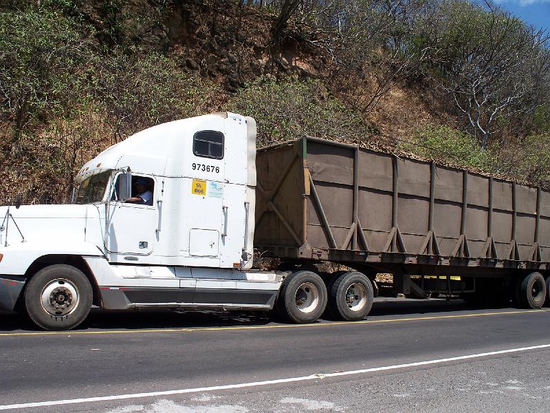 100_1719.jpg - These darn sugar cane trucks really slow traffic down.  So people try to pass, but the roads are very windy.  Seems dangerous to me!